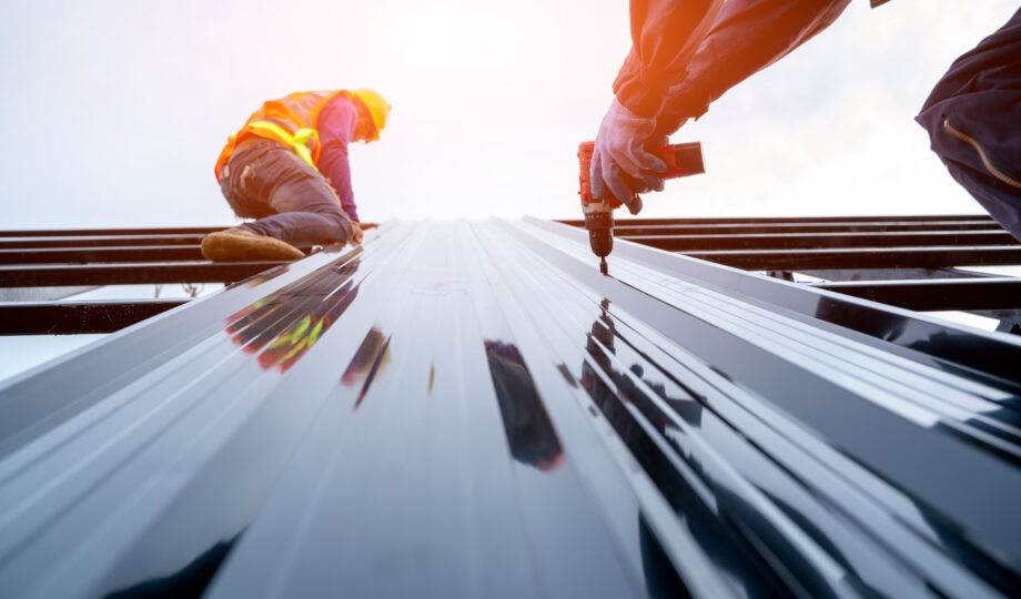 Roofer worker in protective uniform wear and gloves,Concept of residential building under construction. Roofer worker in protective uniform wear and gloves,Concept of residential building under construction.